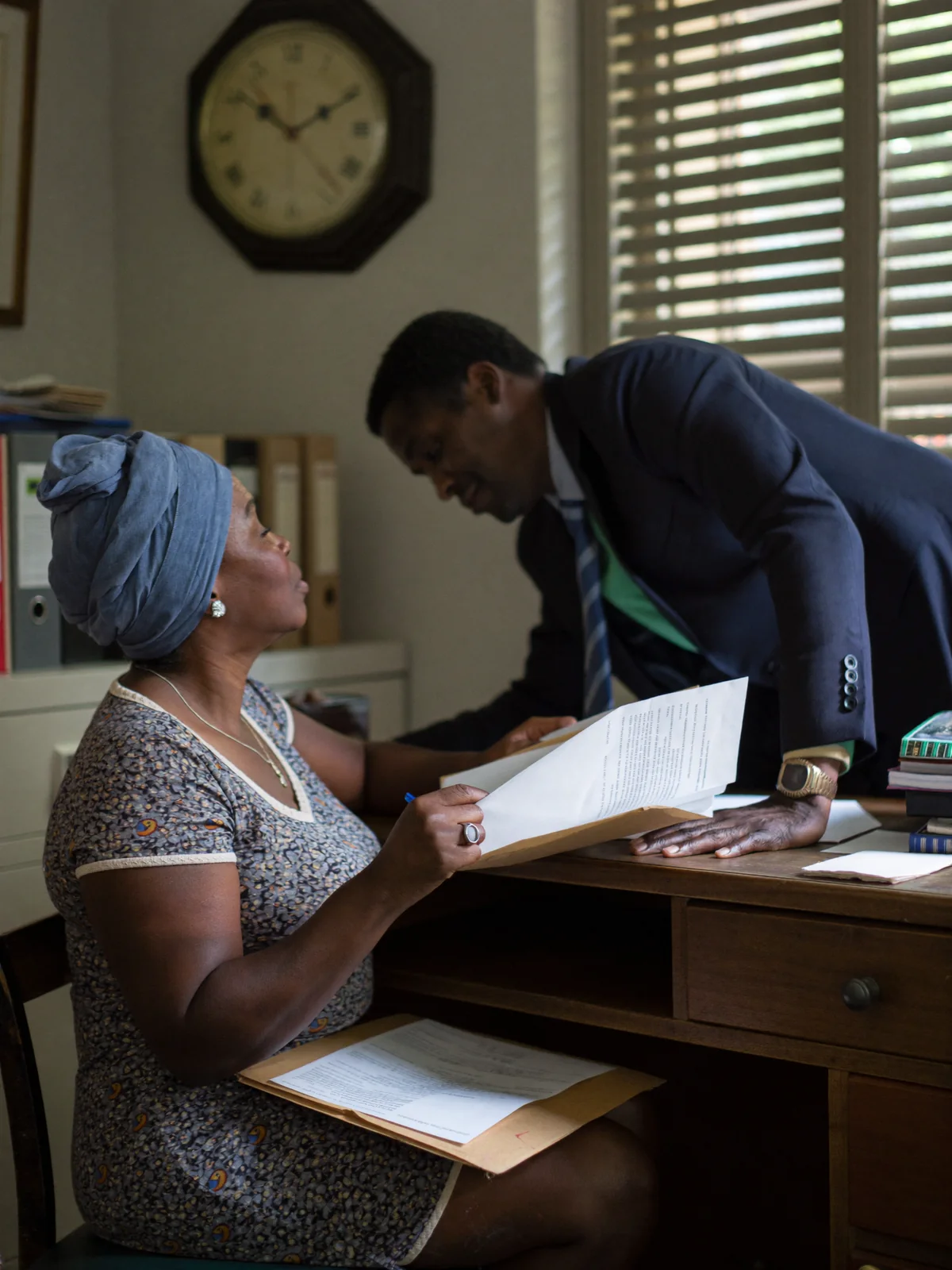 A 256 Tax Consultants specialist listening attentively to a client across a desk in a Kampala office